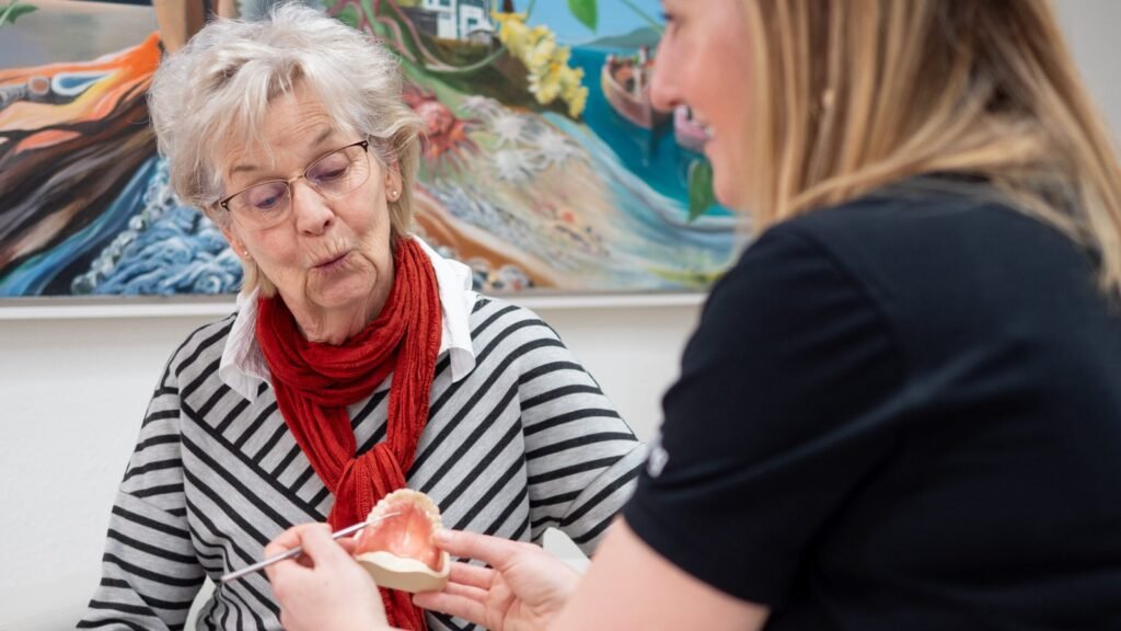 Doctor explaining dentures to a senior patient